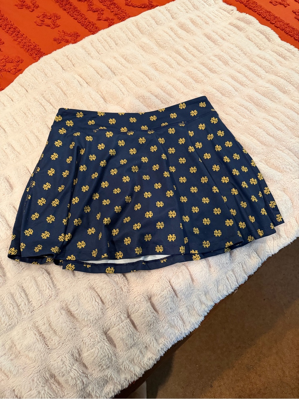 Navy Blue Pleated Skirt with Gold Logo Print